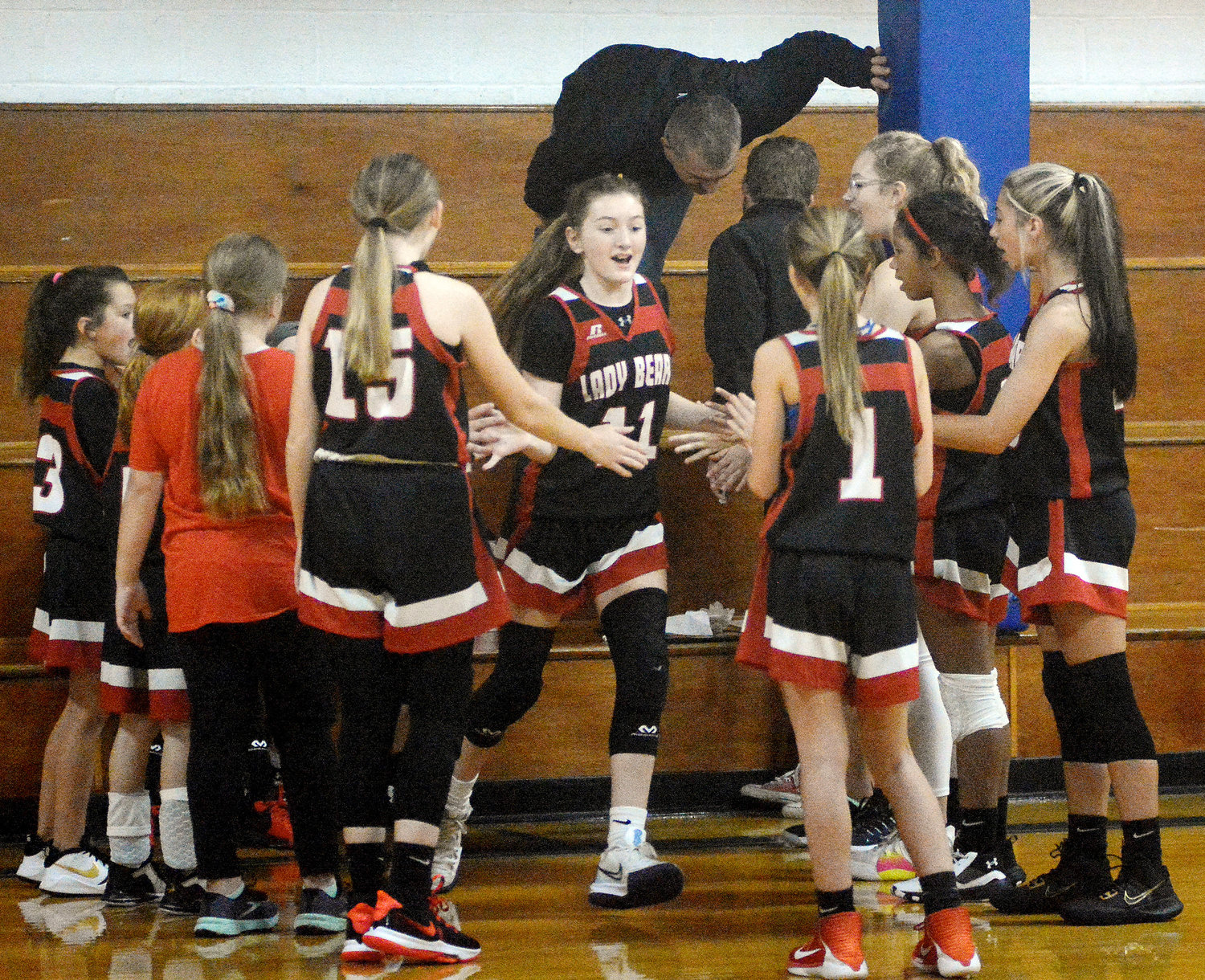 Ava Feeler (center) get high fives from her Bland Lady Bear basketball teammates as her name is announced as one of the starters prior to last Thursday’s middle school daytime basketball game in Crawford County against Bourbon’s Lady Warhawks.